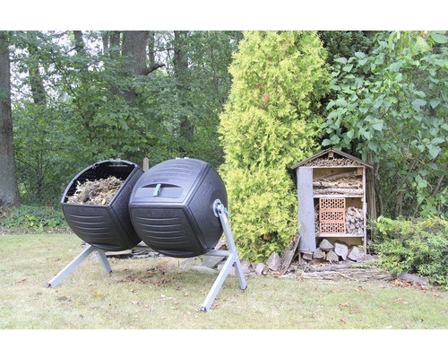 Zwei Komposttrommeln aus Kunststoff und ein Insektenhotel im Garten