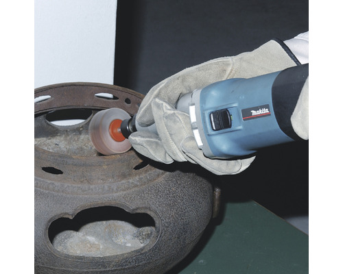 Eine Person benutzt einen Geradschleifer der Marke Makita, um ein Metallobjekt zu reinigen.