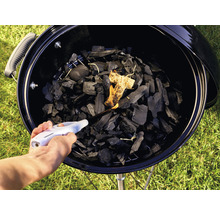 Anzünden von Holzkohle in einem Grill mit einem Feuerzeug