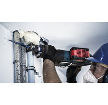 Handwerker sägt Rohr mit einer Säbelsäge