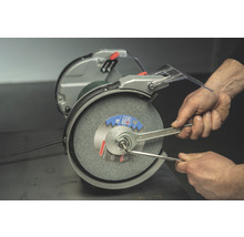 Doppelschleifer mit Mann, der Schraubenschlüssel benutzt