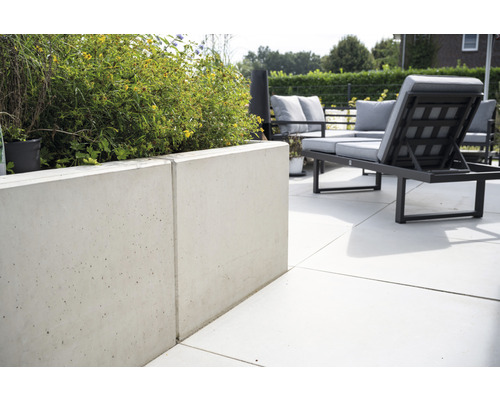 Außenbereich mit Betonpflanzgefäß und Gartenmöbeln