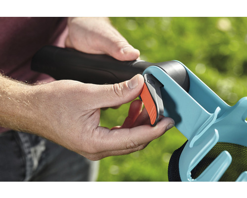 Person betätigt Auslöser an einem Laubsammler.