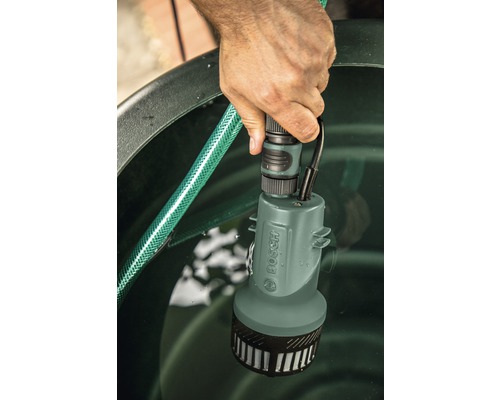 Bosch Logo. Tauchpumpe mit Anschluss an einen Gartenschlauch in einem Behälter