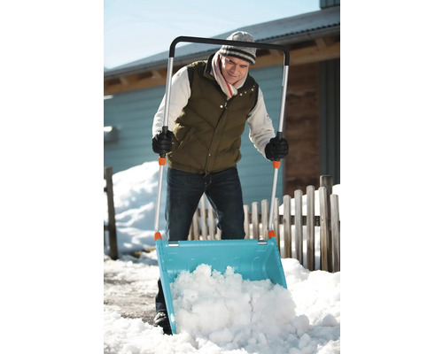 Eine Person benutzt eine Schneeschaufel zum Schneeräumen
