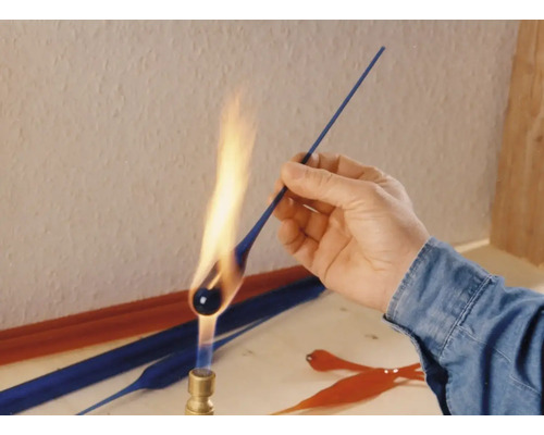 Glasmacher formt Glas mit einer Flamme