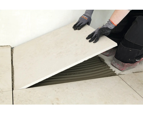 Fliesenleger verlegt Bodenfliese