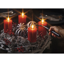 Adventskranz mit roten Kerzen, silberfarbenen Kugeln, roten Beeren und Stabfeuerzeug.