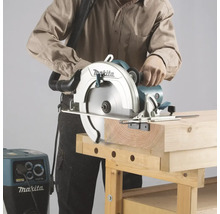 Eine Person sägt mit einer Makita Handkreissäge ein Holzbrett auf einer Werkbank.