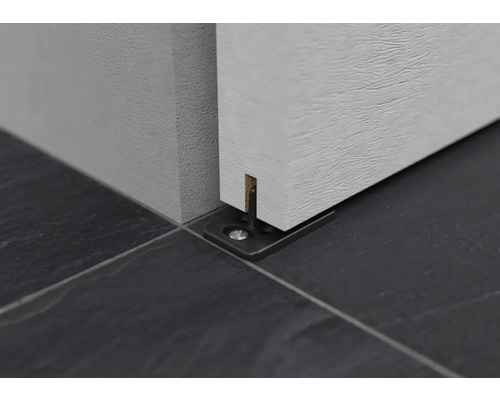 Detailansicht eines Schiebetürsystems mit Bodenführungsschiene auf Fliesenboden.