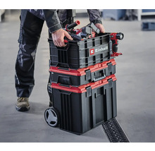 Person transportiert Einhell Werkzeugkoffer-Set mit Werkzeugen