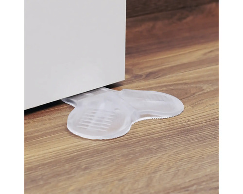 Transparenter Türstopper aus Kunststoff unter einer Tür auf einem Holzboden