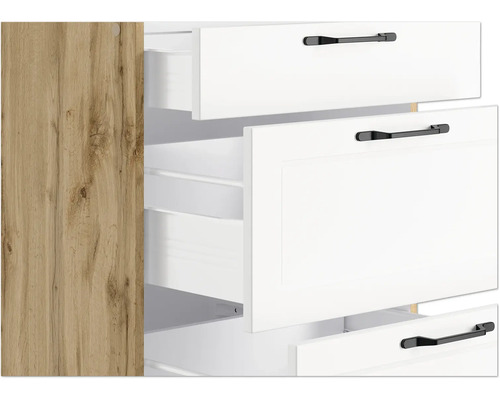 Detailaufnahme eines Schranks mit weißen Schubladen und Holzstruktur an der Seite.