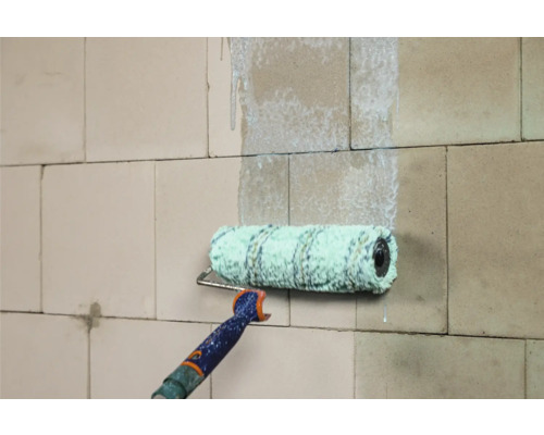 Farbroller beim Auftragen von Farbe auf eine Wand.