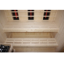 Innenansicht einer Sauna mit Holzsitzen und Infrarotstrahlern an der Decke