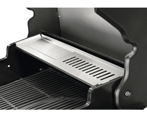 Detailansicht des Innenraums eines Grills mit Warmhalterost und Grillrost.