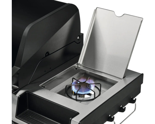 Detailansicht eines Gasgrills mit Seitenbrenner im Betrieb und geöffnetem Deckel