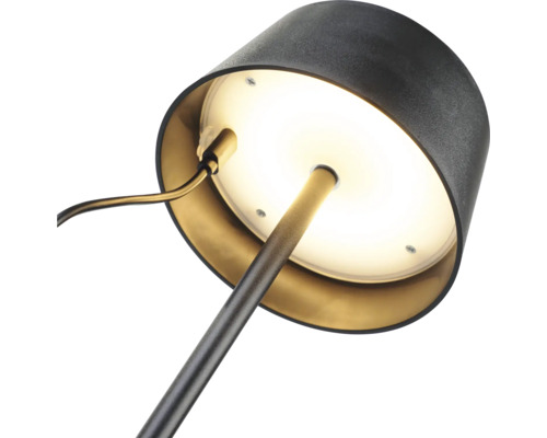 Nahaufnahme einer Schreibtischlampe mit runder Basis und Lampenschirm.