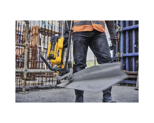 Mann mit Akku-Betonrüttler auf einer Baustelle