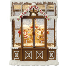 Dekorative Schneekugel in Form eines Lebkuchenhauses mit Lebkuchenmännern