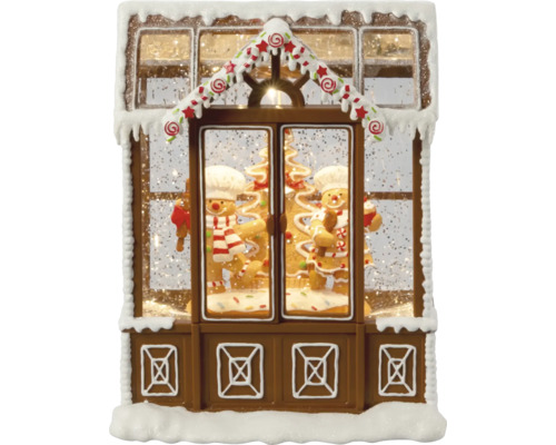 Dekorative Schneekugel in Form eines Lebkuchenhauses mit Lebkuchenmännern