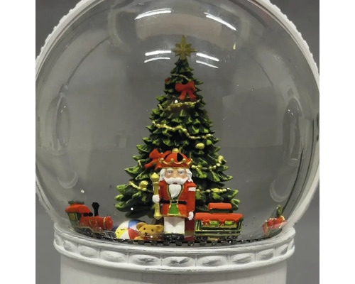 Schneekugel mit Nussknacker, Weihnachtsbaum und Spielzeugeisenbahn