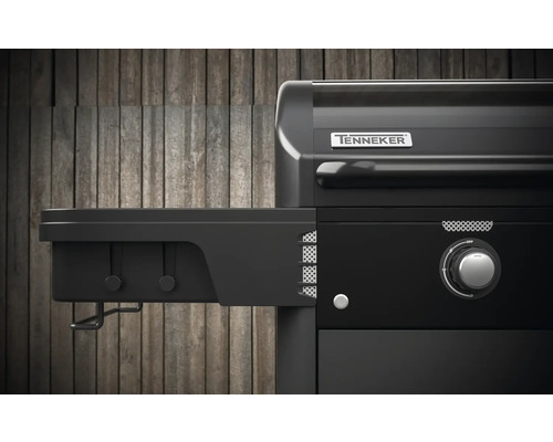 Detailansicht eines schwarzen Gasgrills mit Seitenablage und Tenneker Logo.