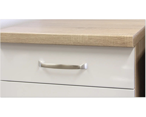 Detailaufnahme eines Schubladenelements mit Griff und einer Tischplatte in Holzoptik.