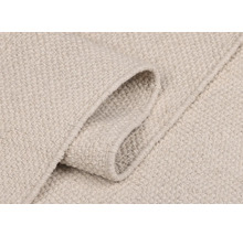 Nahaufnahme eines hellen Teppichs mit Textilmuster