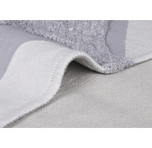 Detailansicht eines grauen Badvorlegers mit Flor und gewebter Rückseite.