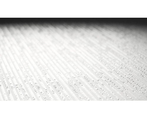 Nahaufnahme einer strukturierten, hellen Oberfläche mit erhabenen, gerillten Linien.