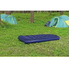 Campingplatz mit Luftmatratze, Zelten und Rucksack im Grünen