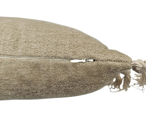 Detailansicht eines Kissens mit Reißverschluss und Zierquaste