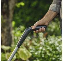 Eine Person hält den Griff eines Gartengeräts der Marke Gardena