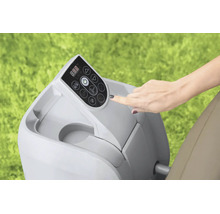 Hand bedient das digitale Bedienfeld einer Whirlpool-Pumpe im Außenbereich auf einer Rasenfläche.