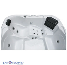 Innenansicht eines Whirlpools mit Massagedüsen, Nackenstütze und San Technik International Logo