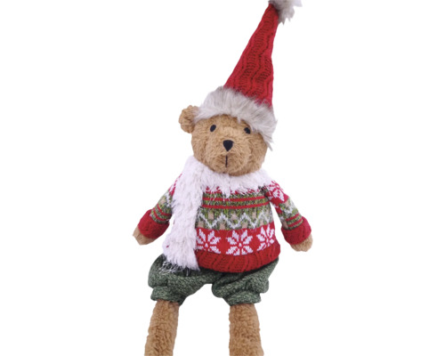 Teddybär in Winterkleidung mit Zipfelmütze, gemustertem Strickpullover, Schal und Hose als Weihnachtsdekoration.