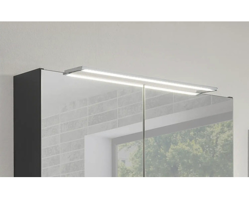Moderner Badezimmer-Spiegelschrank mit einer flachen, hell leuchtenden LED-Aufsatzleuchte.