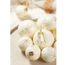 Cremefarbene Weihnachtskugeln aus Glas mit goldenem Sternenmuster aus Glitzer in verschiedenen Größen.