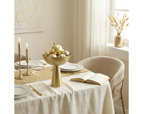 Festlich gedeckter Esstisch mit goldener Schale, Weihnachtskugeln, Kerzenständern, weißem Geschirr mit Goldrand und goldenem Besteck.