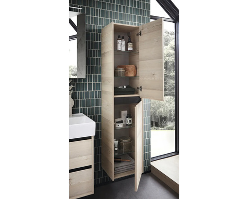 Wandhängender Badezimmer-Hochschrank in heller Holzoptik mit zwei geöffneten Türen, Glaseinlegeböden und Badutensilien neben einem Waschtisch.