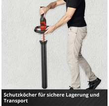 Person steckt eine Heckenschere in einen schwarzen Schutzköcher für sichere Lagerung und Transport.