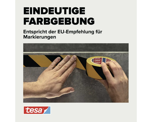 Eine Person klebt schwarz gelbes Warnband auf einen Boden. Das tesa Markierungsband entspricht der europäischen Empfehlung für Kennzeichnungen.