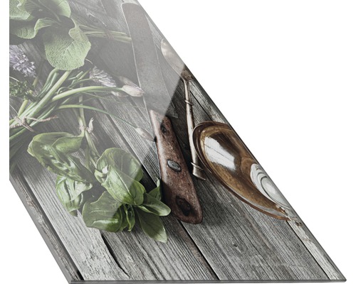 Küchenkräuter und Küchenutensilien auf Holz