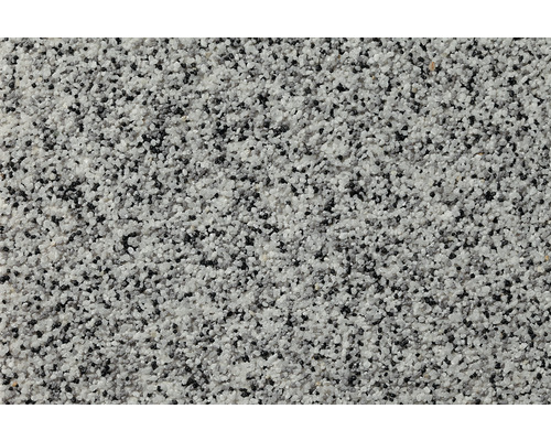Nahaufnahme einer Putzoberfläche mit grauen und schwarzen Steinchen.