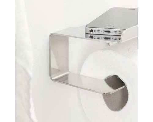 Toilettenpapierhalter mit Ablagefläche für ein Mobiltelefon.