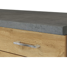 Detailaufnahme eines Schubladenelements mit Platte in Betonoptik und einem Griff aus Metall