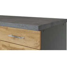 Detailansicht eines Schranks mit Schubladen, einer grauen Arbeitsplatte und silberfarbenen Griffen