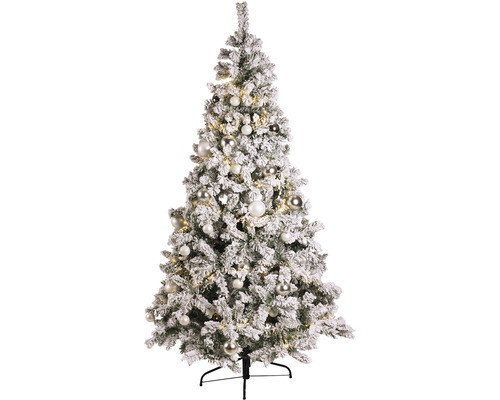 Verschneiter künstlicher Weihnachtsbaum mit Christbaumkugeln und Lichtern