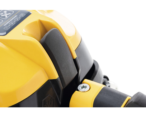 Detailaufnahme eines gelben Geräts mit schwarzem Hebel und Bedienungsanleitung.